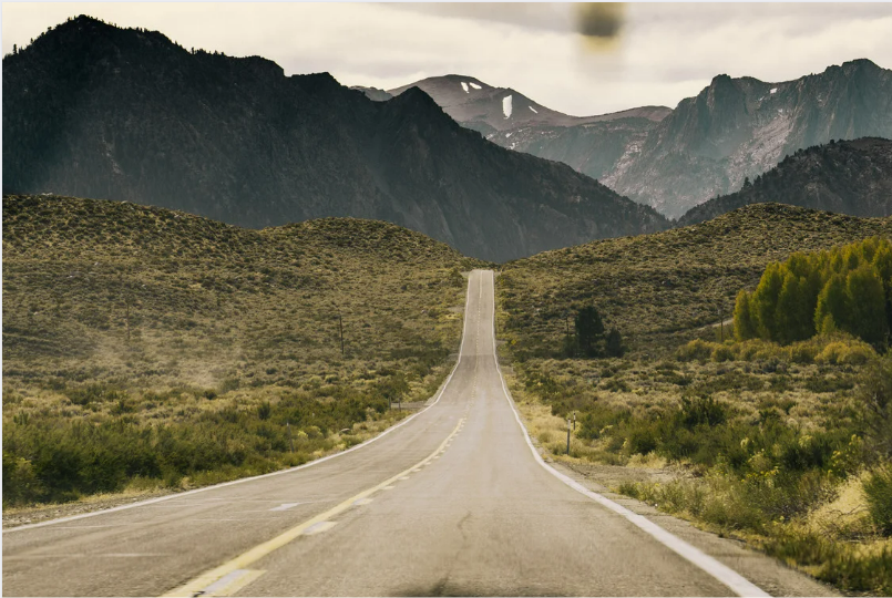 Practical Steps for Measuring and Reducing Your Business' Carbon Footprint | Zeigo Sustainability Software A road leading to mountains