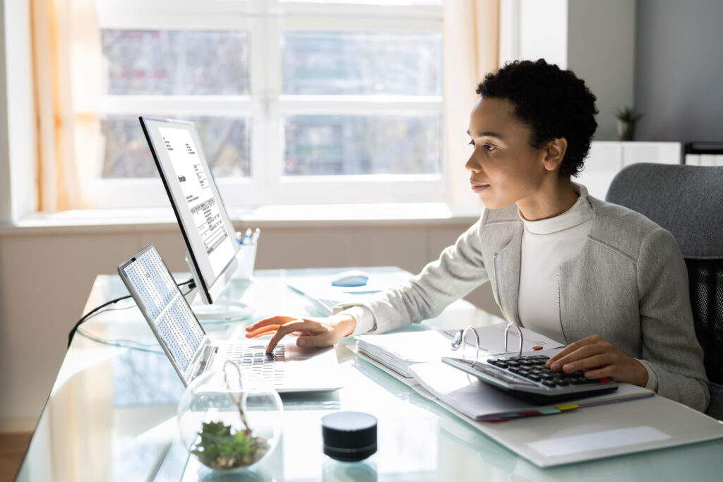 Zeigo Awarded BEST Product-Software & Cloud Implementation 2025 | Zeigo Sustainability Software A woman working on a computer, potentially decarbonizing her sme